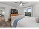 This main bedroom features a ceiling fan, a large window, and an attached seating area at 9013 E Shooting Star Dr, Gold Canyon, AZ 85118
