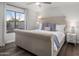 Comfortable main bedroom with a tufted headboard, large window and stylish nightstands at 9013 E Shooting Star Dr, Gold Canyon, AZ 85118