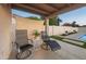 Relaxing covered patio with lounge chairs overlooking a tranquil pool and landscaped backyard at 9013 E Shooting Star Dr, Gold Canyon, AZ 85118