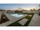 Beautiful pool area featuring a concrete patio, artificial turf, and serene landscaping at 9013 E Shooting Star Dr, Gold Canyon, AZ 85118