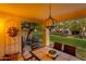 Inviting back patio with views of the community lawn, furnished with comfortable seating and dining at 9121 W Topeka Dr, Peoria, AZ 85382