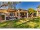 Inviting outdoor patio with plush seating, perfect for relaxing and entertaining, surrounded by manicured lawn at 9121 W Topeka Dr, Peoria, AZ 85382