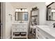 Bright bathroom showcasing dual sinks, modern fixtures, and a decorative storage ladder at 9121 W Topeka Dr, Peoria, AZ 85382