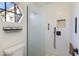 Contemporary bathroom featuring tiled shower with a glass door and a built-in niche at 9121 W Topeka Dr, Peoria, AZ 85382
