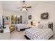 Charming bedroom with two beds, a ceiling fan, and a bright window with outdoor views at 9121 W Topeka Dr, Peoria, AZ 85382