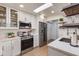 Bright, updated kitchen with white cabinets, stainless steel appliances, and a skylight at 9121 W Topeka Dr, Peoria, AZ 85382