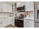 Well-appointed kitchen featuring white cabinets, stainless steel appliances, and quartz countertops at 9121 W Topeka Dr, Peoria, AZ 85382