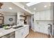 Updated kitchen featuring white cabinets, stainless steel appliances, and breakfast bar at 9121 W Topeka Dr, Peoria, AZ 85382