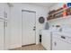 Well-organized laundry area featuring ample storage, modern machines, and clean, bright ambiance at 9121 W Topeka Dr, Peoria, AZ 85382