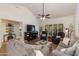Open-concept living room with vaulted ceiling, wood floors, and a large window overlooking the backyard at 9121 W Topeka Dr, Peoria, AZ 85382
