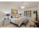 Bright main bedroom featuring ceiling fan, shutters, and stylish decor at 9121 W Topeka Dr, Peoria, AZ 85382