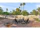 Inviting backyard features a cozy fire pit area, perfect for outdoor entertaining under string lights at 9221 N Camino Vista Ln, Phoenix, AZ 85028