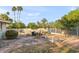 Fenced backyard featuring a garden, sitting area, and lush greenery under a clear sky at 9221 N Camino Vista Ln, Phoenix, AZ 85028
