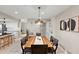 Formal dining area offers a long table and seamlessly connects with a modern kitchen at 9221 N Camino Vista Ln, Phoenix, AZ 85028