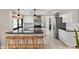 Well-lit kitchen featuring white cabinets, black countertops, stainless steel appliances, and a breakfast bar with seating at 9221 N Camino Vista Ln, Phoenix, AZ 85028