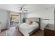 Bright main bedroom with access to outdoor patio, providing a cozy retreat with neutral decor and wood flooring at 9221 N Camino Vista Ln, Phoenix, AZ 85028