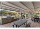 Covered patio with an outdoor kitchen and dining area, perfect for entertaining at 9221 N Camino Vista Ln, Phoenix, AZ 85028