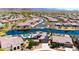Stunning aerial view of a community with lake, lush landscaping, and beautiful desert surroundings at 16683 S 180Th Dr, Goodyear, AZ 85338