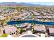 Aerial view of a residential neighborhood featuring lakefront properties, community pools, and well-maintained landscaping at 16683 S 180Th Dr, Goodyear, AZ 85338