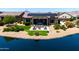 Backyard oasis with a patio, outdoor seating, and lush landscaping near the lake at 16683 S 180Th Dr, Goodyear, AZ 85338