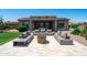 Cozy outdoor seating area with a fire pit, perfect for relaxation and gatherings in your beautiful backyard at 16683 S 180Th Dr, Goodyear, AZ 85338