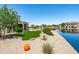Spacious backyard with lake views, inviting patio area, and lush landscaping at 16683 S 180Th Dr, Goodyear, AZ 85338