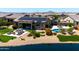 Beautiful backyard featuring a pool, covered patio, outdoor seating, and manicured landscaping near the lake at 16683 S 180Th Dr, Goodyear, AZ 85338