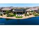 Stunning backyard featuring a lakefront view, outdoor seating, and beautiful landscaping at 16683 S 180Th Dr, Goodyear, AZ 85338