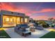 Cozy outdoor patio with a fire pit, comfortable seating, and a stunning desert sunset at 16683 S 180Th Dr, Goodyear, AZ 85338