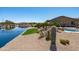 Resort style backyard with lake views, beautiful cacti, and outdoor seating area at 16683 S 180Th Dr, Goodyear, AZ 85338