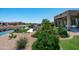 Scenic backyard featuring lush greenery, a tranquil lake, and a charming patio at 16683 S 180Th Dr, Goodyear, AZ 85338