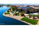 Waterfront backyard featuring a pool, lush landscaping, and outdoor seating at 16683 S 180Th Dr, Goodyear, AZ 85338