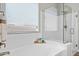 Bright bathroom showcasing a tub and a shower with clear glass doors at 16683 S 180Th Dr, Goodyear, AZ 85338