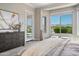 Inviting bedroom featuring a plush bed, dresser, and a door leading to the outside at 16683 S 180Th Dr, Goodyear, AZ 85338