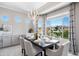 Dining room has pond view, large window, light fixture, and a dining table at 16683 S 180Th Dr, Goodyear, AZ 85338