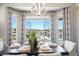 Dining room is set with table and chairs, has a pond view and lots of natural light at 16683 S 180Th Dr, Goodyear, AZ 85338