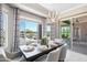 Dining room features a dining table, chandelier, curtains, and a sliding glass door at 16683 S 180Th Dr, Goodyear, AZ 85338