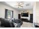 This home theater boasts comfortable seating, ceiling fan, and a large screen, perfect for movie nights at 16683 S 180Th Dr, Goodyear, AZ 85338