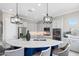 Spacious kitchen features an island with breakfast bar, stainless steel appliances, gray cabinets and pendant lighting at 16683 S 180Th Dr, Goodyear, AZ 85338