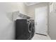 A well-organized laundry room features modern appliances and ample shelving for storage and convenience at 16683 S 180Th Dr, Goodyear, AZ 85338