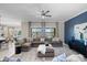 Inviting living room with stylish decor, comfortable seating, and scenic backyard views at 16683 S 180Th Dr, Goodyear, AZ 85338