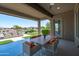 The covered patio has dining and overlooks a pond for outdoor dining and entertaining with scenic views at 16683 S 180Th Dr, Goodyear, AZ 85338