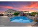 Backyard pool area with lounge chairs, barbecue, and a beautifully landscaped patio at 16683 S 180Th Dr, Goodyear, AZ 85338