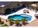 Aerial view of the backyard pool area featuring mature landscaping and comfortable outdoor seating at 16683 S 180Th Dr, Goodyear, AZ 85338