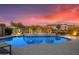 Sparkling pool with tropical palms and lush plants creating a private oasis at 16683 S 180Th Dr, Goodyear, AZ 85338