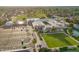 Aerial view showcases the clubhouse, pool, and parking, plus recreation of a grassy lawn bowling area at 2245 Leisure World --, Mesa, AZ 85206