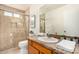 Bathroom showcasing a glass-enclosed shower, vanity with a stone countertop, and ample lighting at 2245 Leisure World --, Mesa, AZ 85206