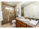 Bathroom with a glass-enclosed shower, vanity with a stone countertop, and ample lighting at 2245 Leisure World --, Mesa, AZ 85206