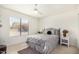 Sunlit bedroom featuring a large window, ceiling fan, and comfortable, stylish bed at 2245 Leisure World --, Mesa, AZ 85206