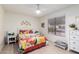 Charming bedroom with bright decor and floral accents, tile floors and window at 2245 Leisure World --, Mesa, AZ 85206